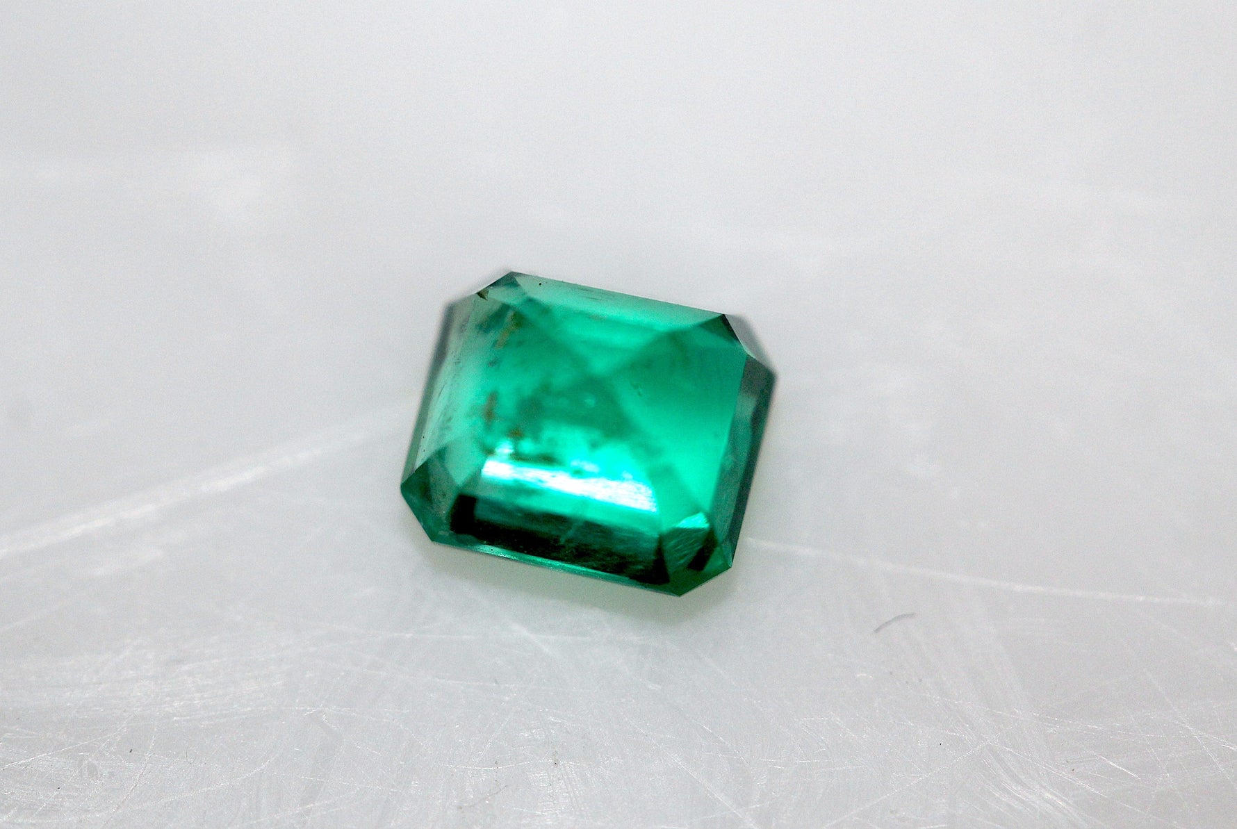 back side of precious loose emerald stone